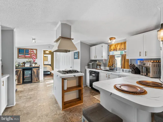 a kitchen with sink stove and refrigerator