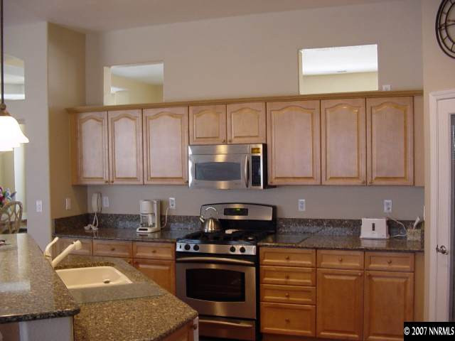 1810 Arboleda Court Reno, NV 89521 - Photo 3 of 9 a kitchen with granite countertop a stove sink and cabinets