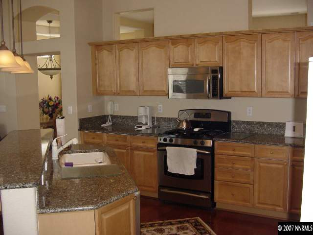 1810 Arboleda Court Reno, NV 89521 - Photo 4 of 9 a kitchen with granite countertop a sink stove and cabinets