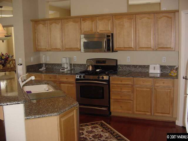 1810 Arboleda Court Reno, NV 89521 - Photo 5 of 9 a kitchen with granite countertop a sink and a stove