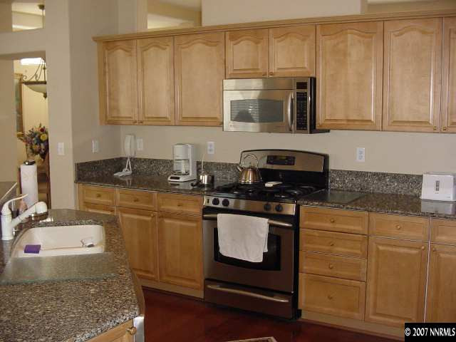 1810 Arboleda Court Reno, NV 89521 - Photo 6 of 9 a kitchen with stainless steel appliances granite countertop a sink stove and microwave