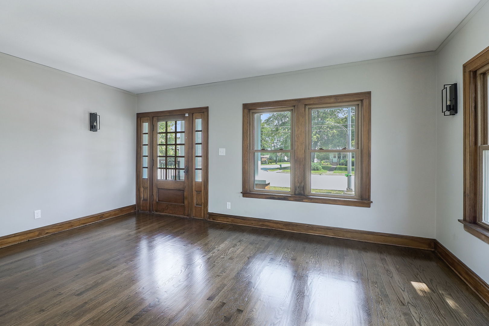 824 State Street Lemont, IL 60439 - Photo 3 of 31 a view of an empty room with wooden floor and a window