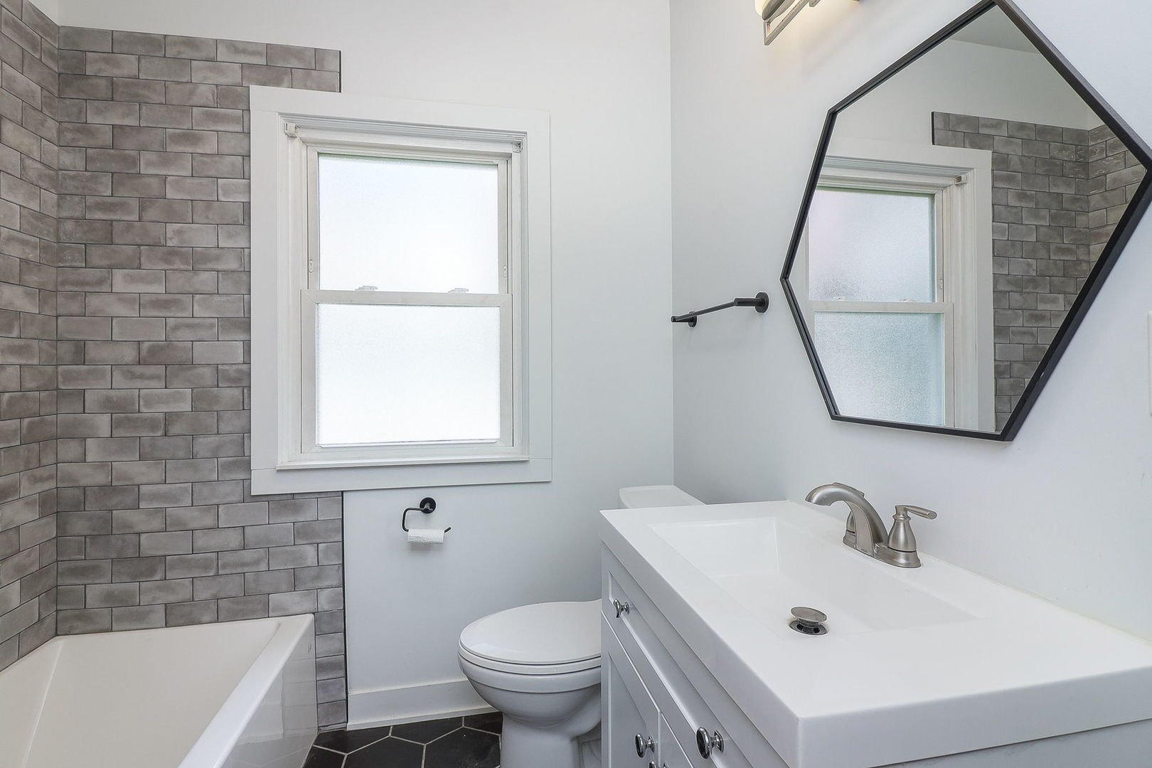 824 State Street Lemont, IL 60439 - Photo 10 of 31 a white bath tub sitting next to a white sink and a toilet