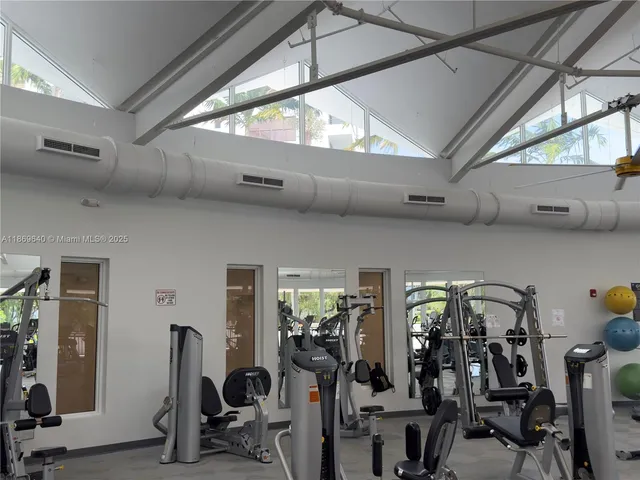 a living room with fireplace furniture and a large window