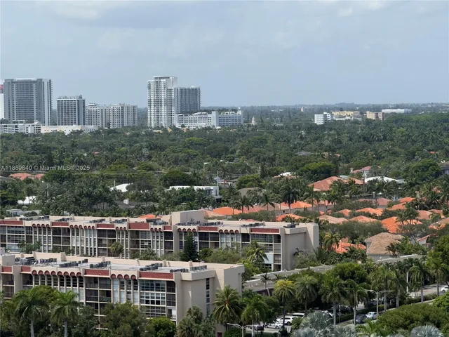 a view of a swimming pool with a yard and potted plants
