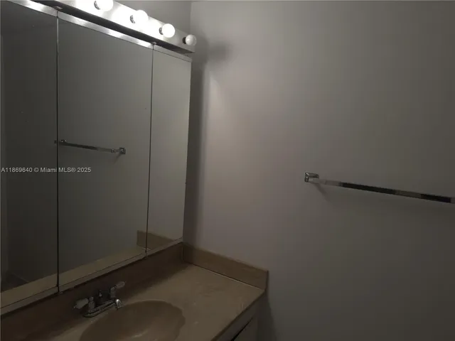 a bathroom with a sink and vanity