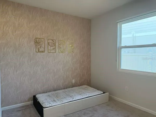 a room with a bed and a window