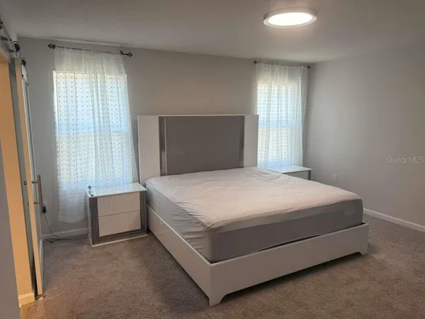 a bedroom with a bed and window