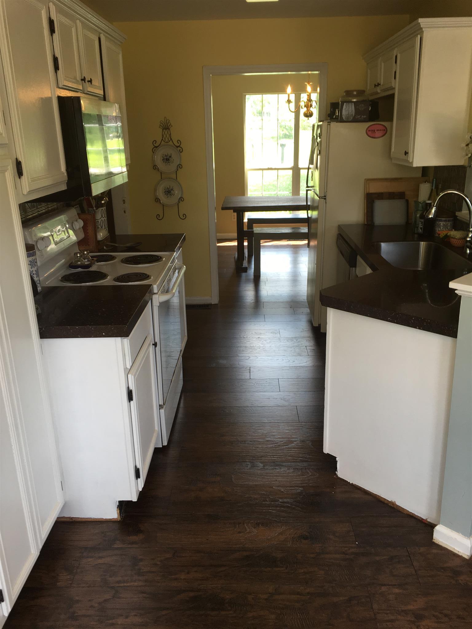 3618 Rutherford Drive Spring Hill, TN 37174 - Photo 13 of 21 a kitchen with granite countertop a sink stove and wooden floor