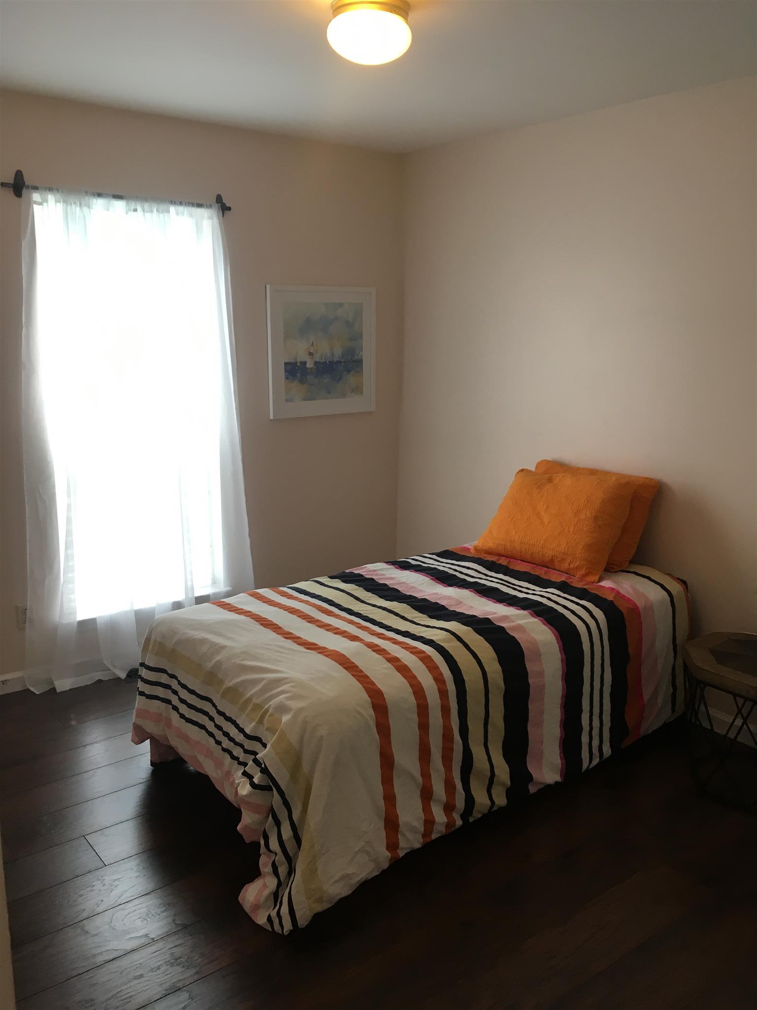 3618 Rutherford Drive Spring Hill, TN 37174 - Photo 18 of 21 a bedroom with a bed lamp and window