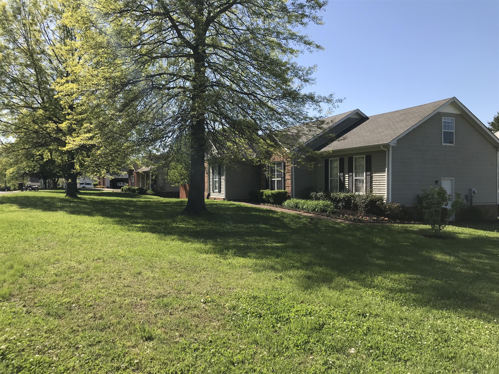 3618 Rutherford Drive Spring Hill, TN 37174 - Photo 3 of 21 a view of a house with a big yard and large trees