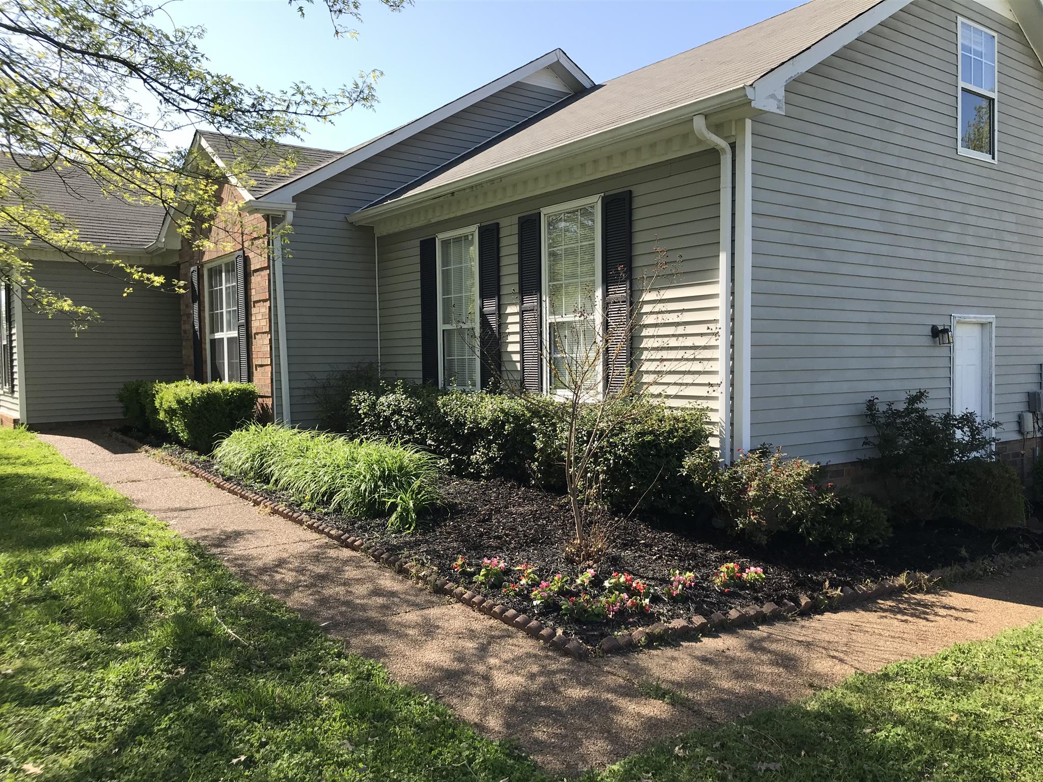 3618 Rutherford Drive Spring Hill, TN 37174 - Photo 4 of 21 a front view of a house with a yard and plants