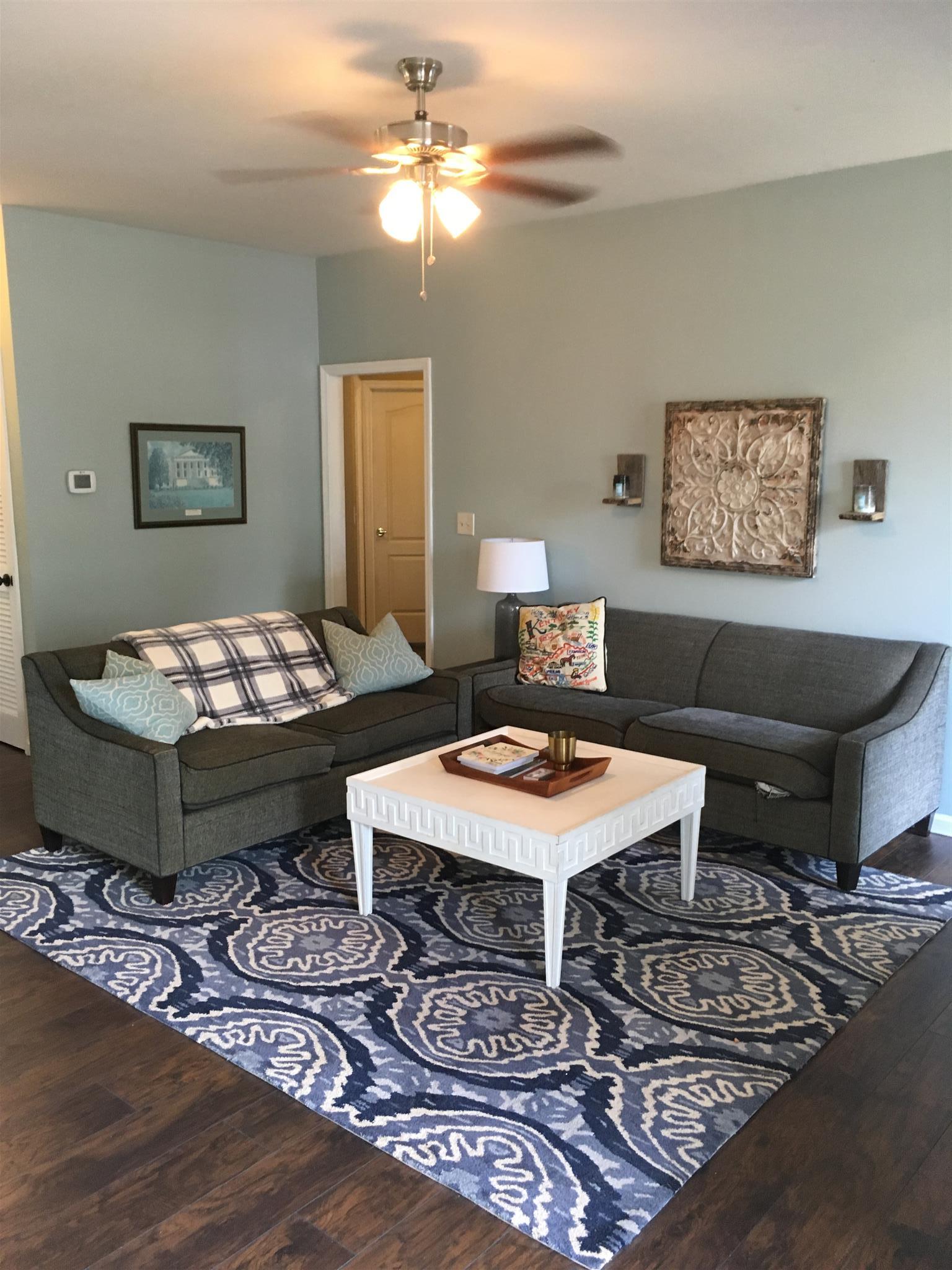 3618 Rutherford Drive Spring Hill, TN 37174 - Photo 6 of 21 a living room with furniture a chandelier and a table