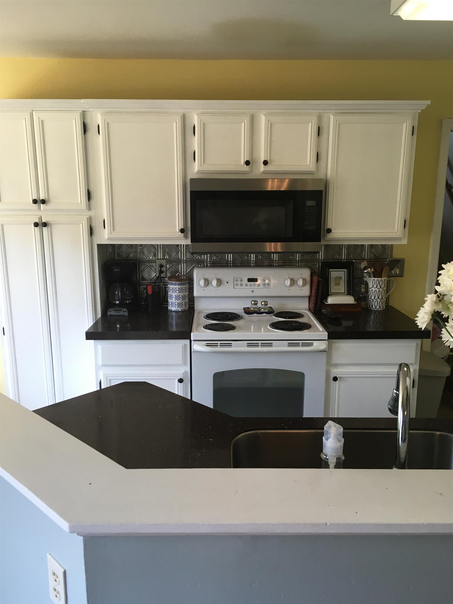3618 Rutherford Drive Spring Hill, TN 37174 - Photo 9 of 21 a kitchen with stainless steel appliances a stove a white cabinets and a sink