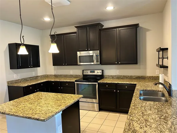 a kitchen with a sink stove and refrigerator