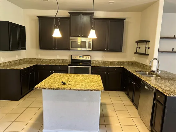 a kitchen with a sink and a refrigerator