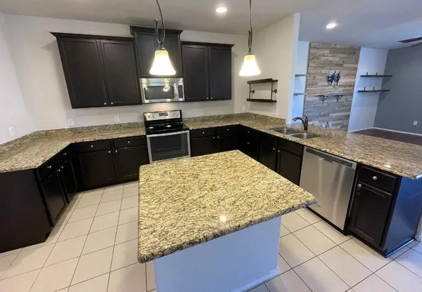 a kitchen with a sink stove and refrigerator