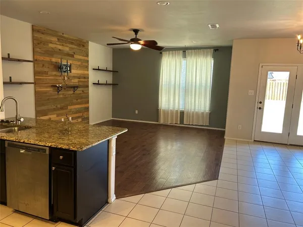 a kitchen with stainless steel appliances granite countertop a sink and a stove