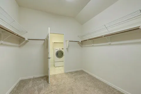 a view of a storage & utility room with refrigerator