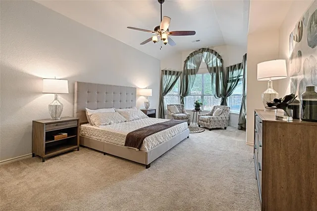 a bedroom with bed and a chandelier