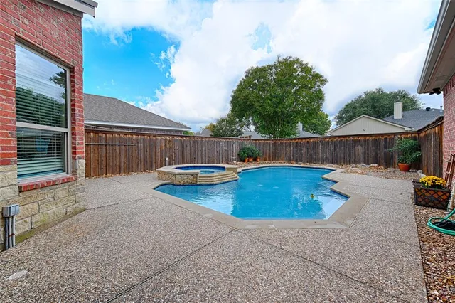 a view of a backyard with swimming pool