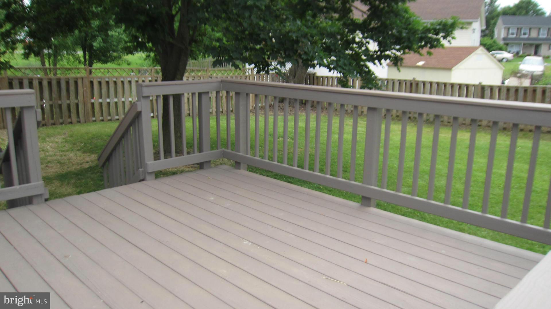 Large rear deck with Maple tree shade