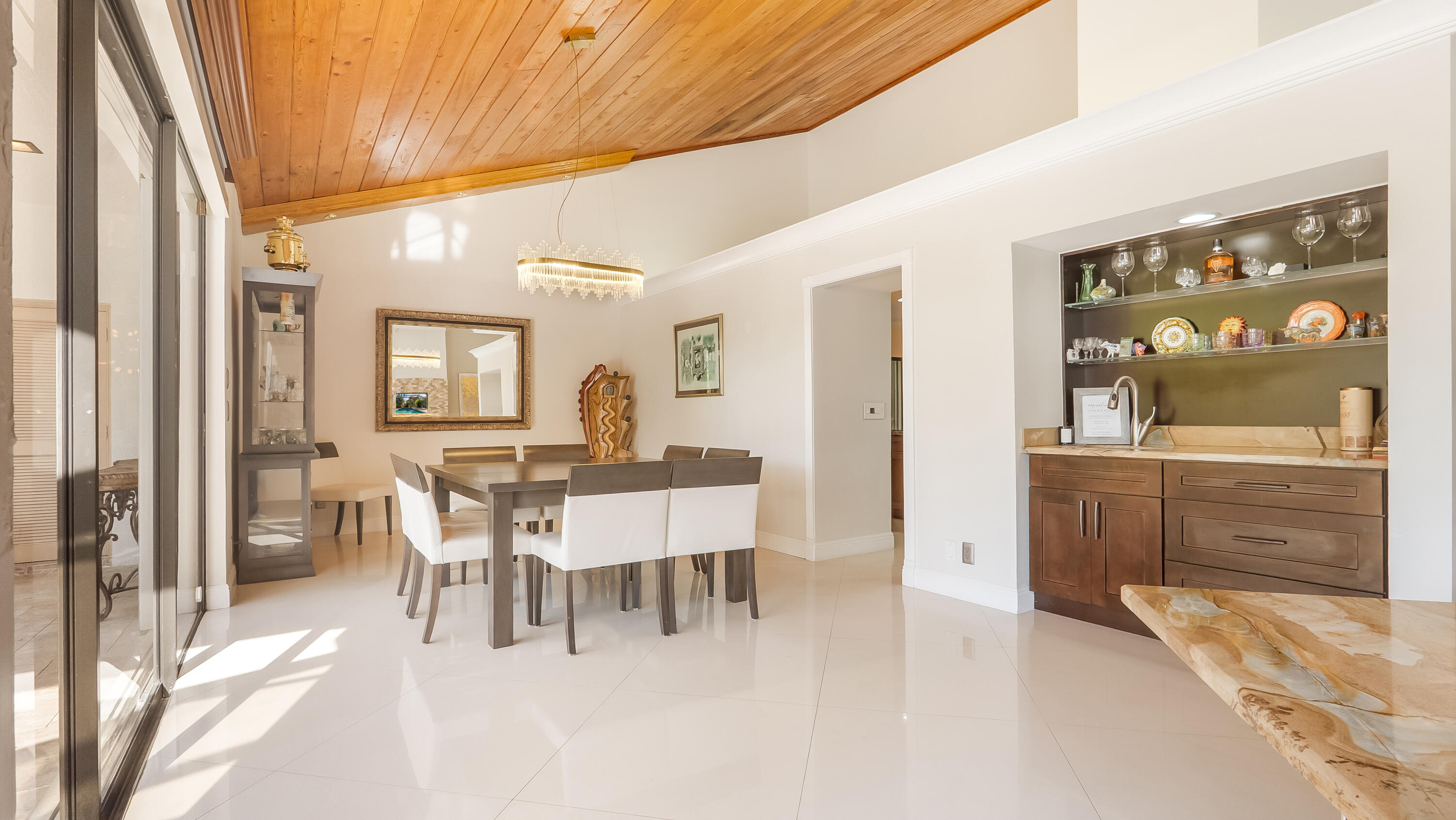 10571 Boca Woods Lane Boca Raton, FL 33428 - Photo 13 of 81 a view of a dining room with furniture and chandelier
