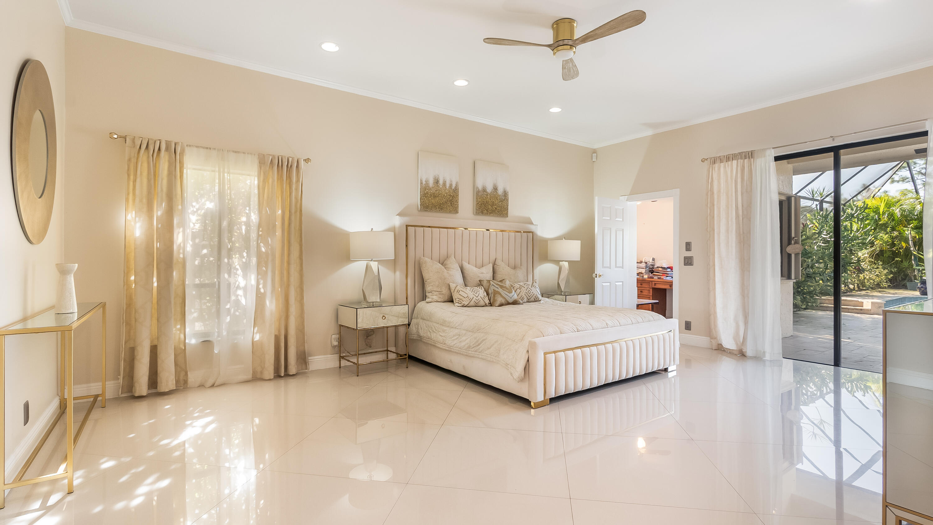 10571 Boca Woods Lane Boca Raton, FL 33428 - Photo 16 of 81 a bedroom with a large bed and a chandelier