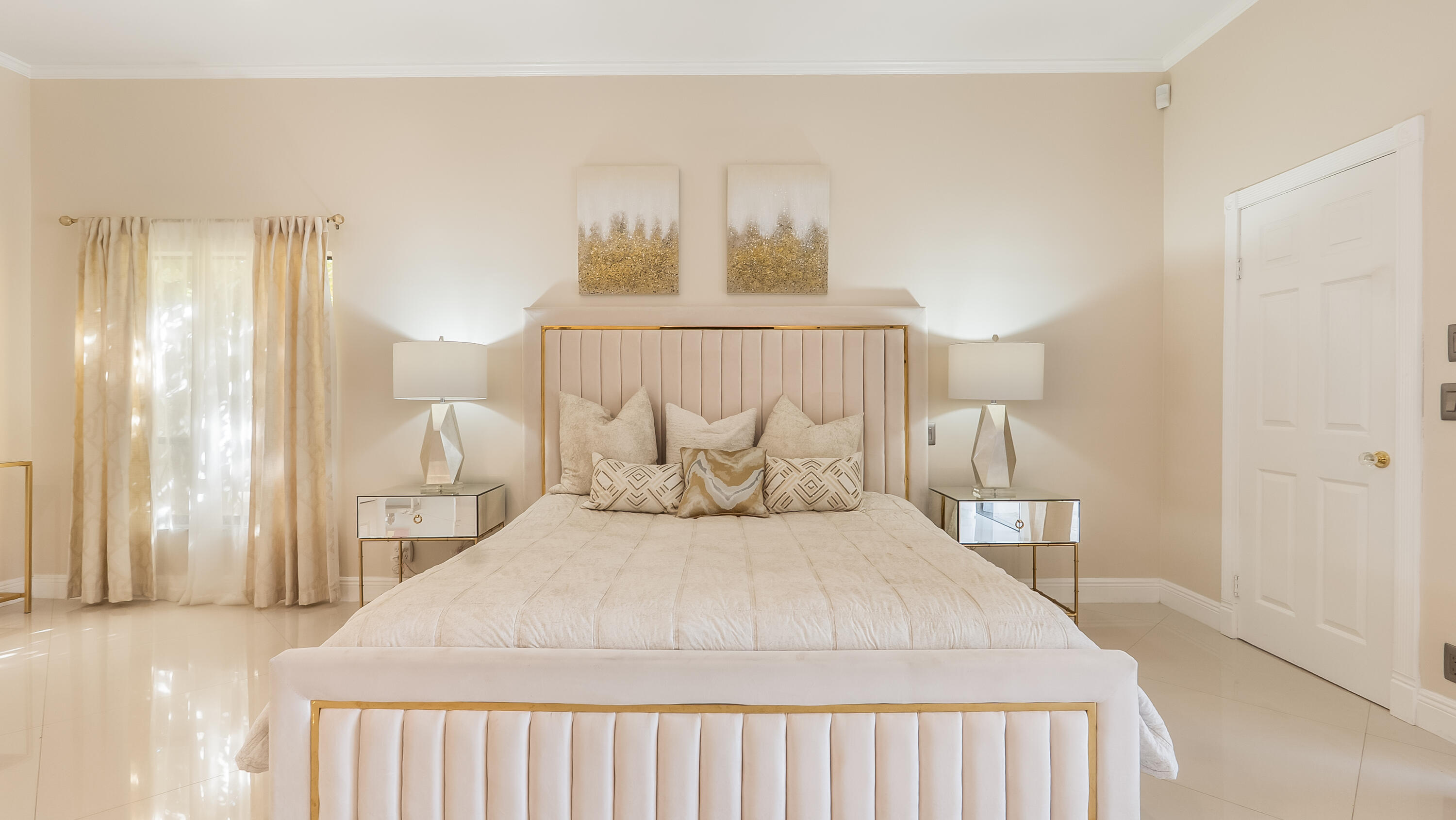 10571 Boca Woods Lane Boca Raton, FL 33428 - Photo 19 of 81 a bedroom with a large bed and a chandelier