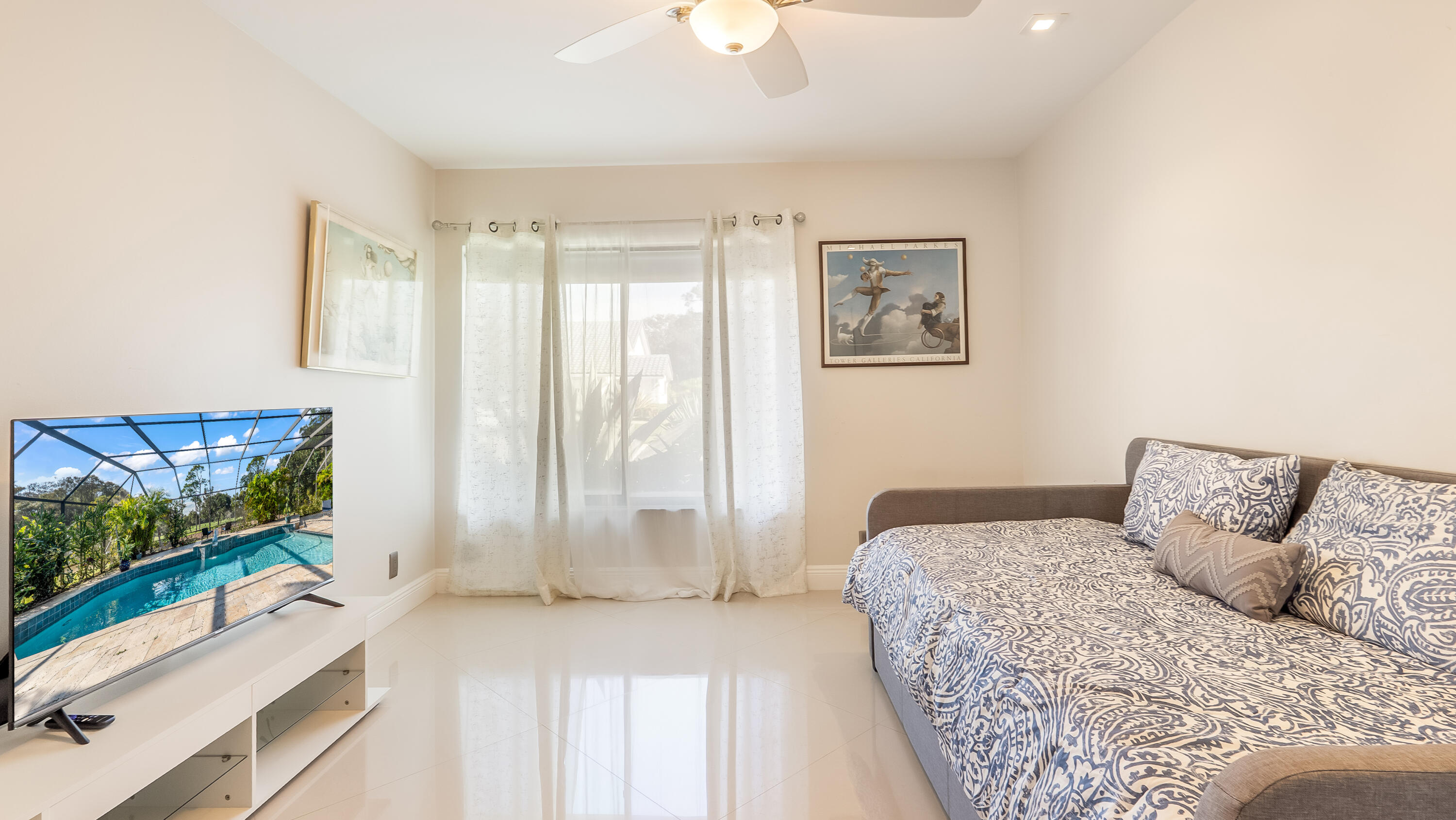 10571 Boca Woods Lane Boca Raton, FL 33428 - Photo 29 of 81 a bedroom with a large bed and a flat tv screen on dresser