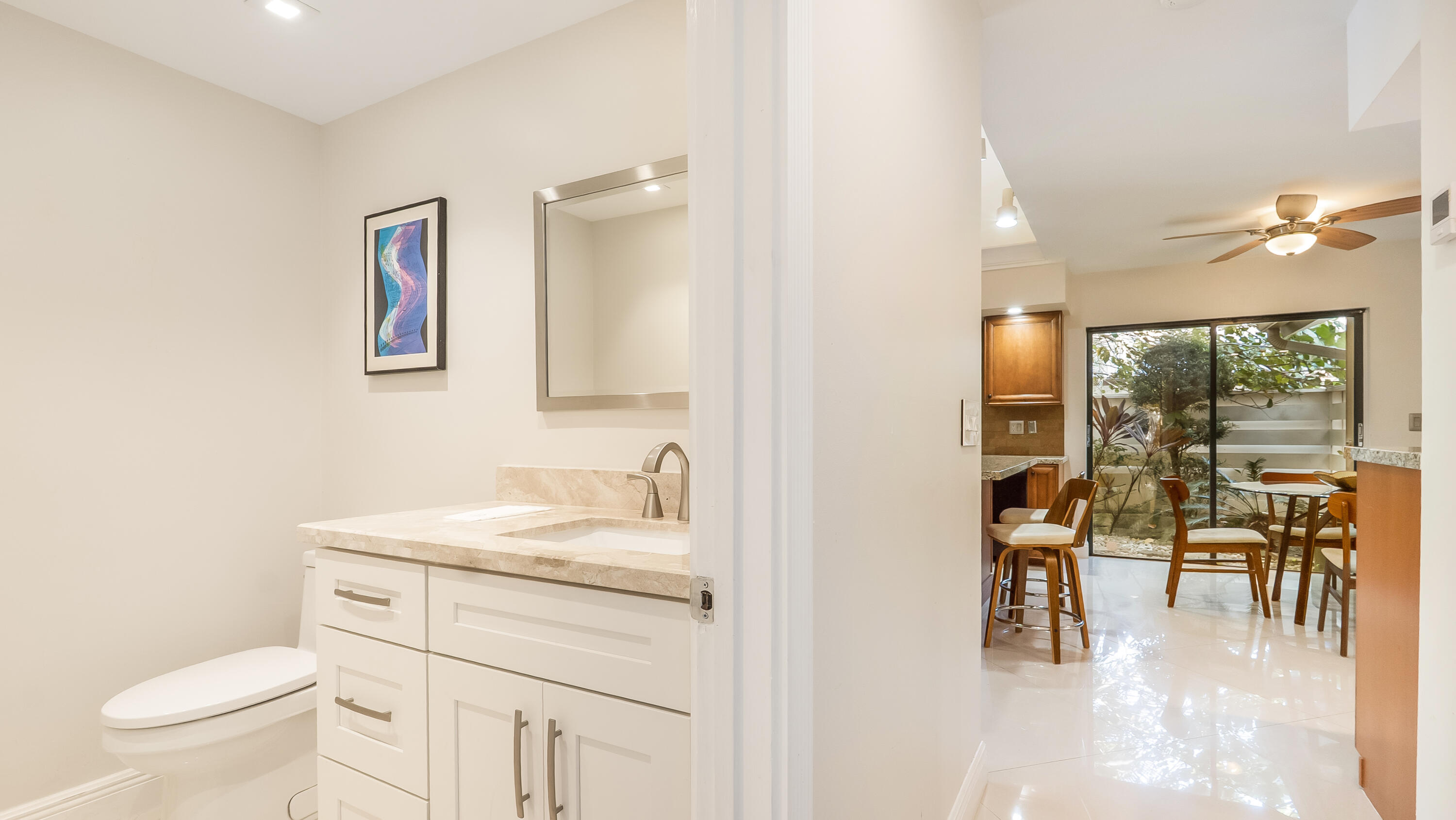 10571 Boca Woods Lane Boca Raton, FL 33428 - Photo 35 of 81 a bathroom with a sink a toilet a mirror and a shower