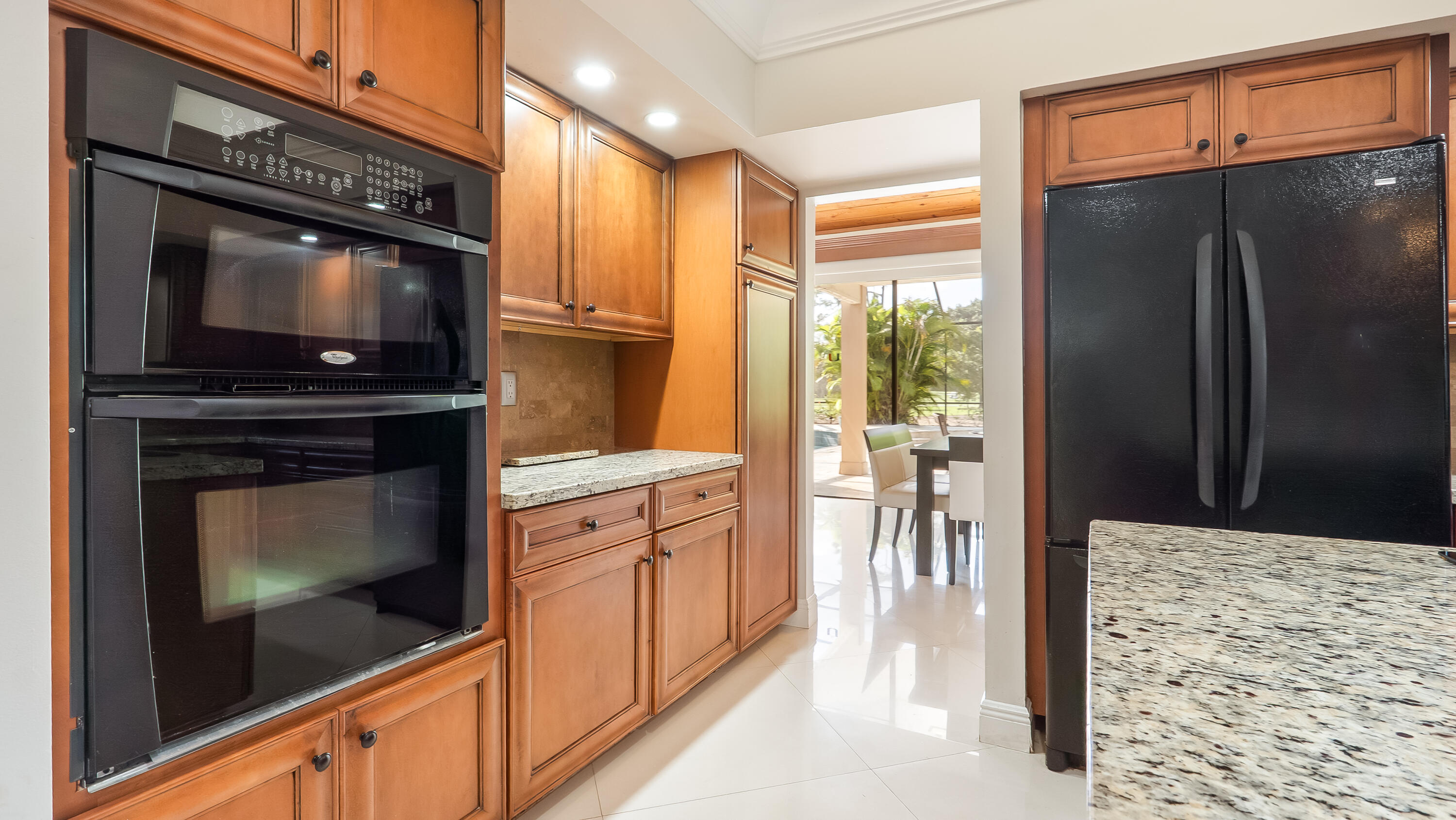 10571 Boca Woods Lane Boca Raton, FL 33428 - Photo 37 of 81 a kitchen with stainless steel appliances a refrigerator stove and cabinets