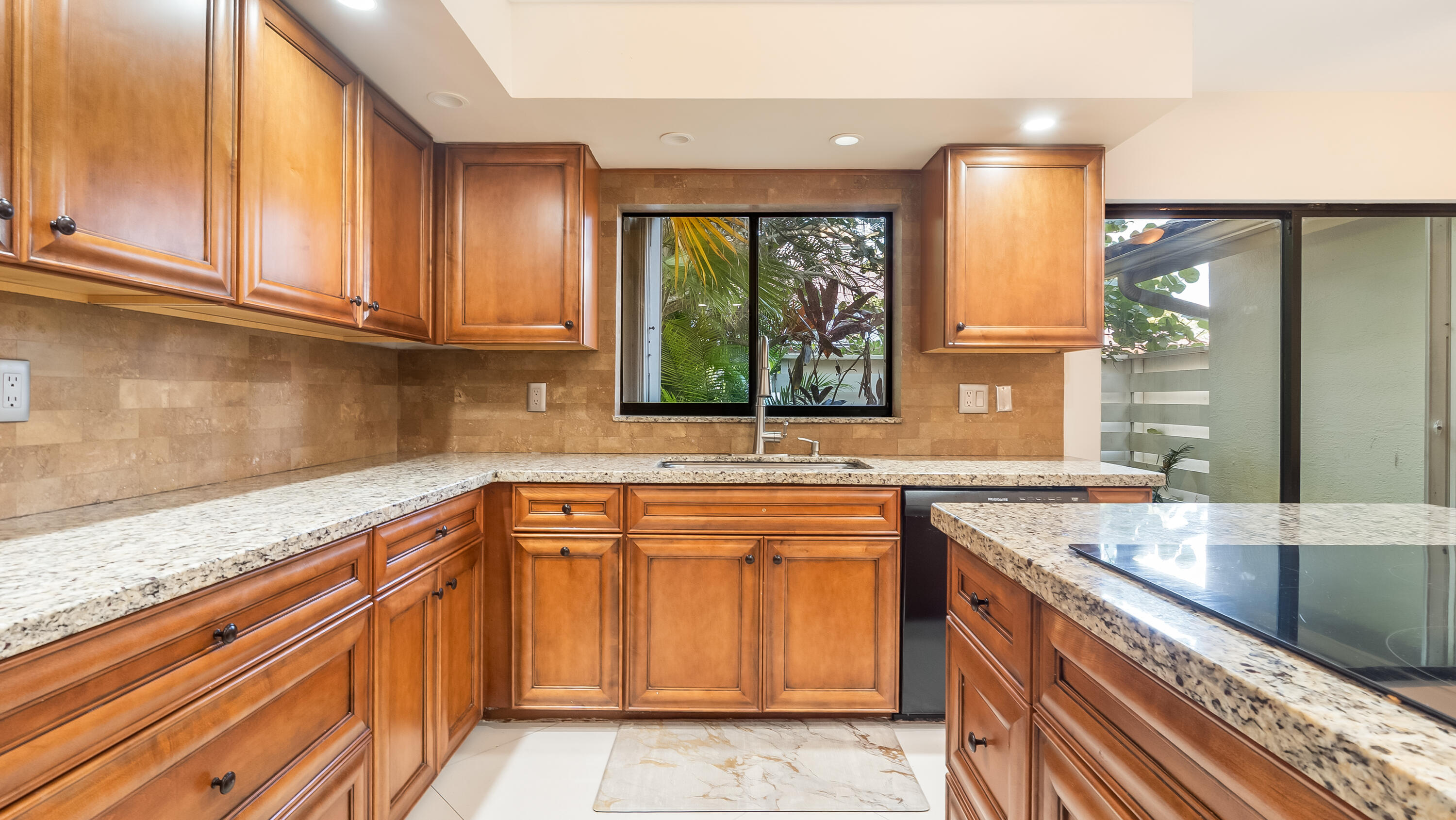 10571 Boca Woods Lane Boca Raton, FL 33428 - Photo 38 of 81 a kitchen with granite countertop a sink and a stove