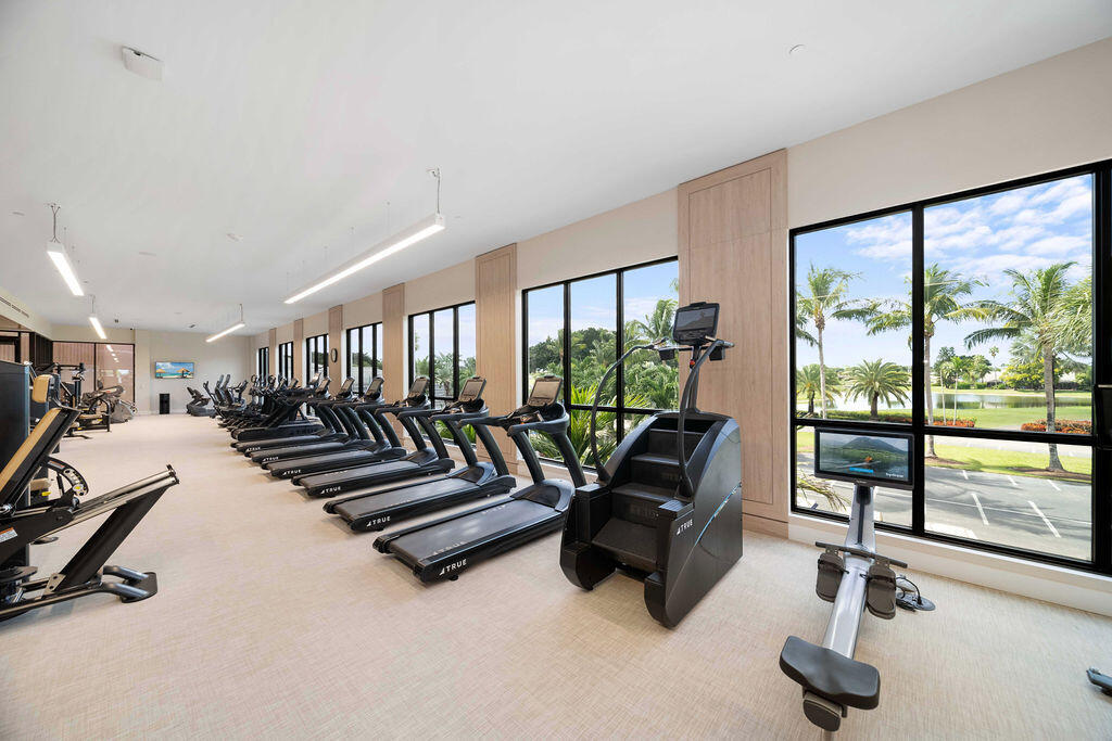 10571 Boca Woods Lane Boca Raton, FL 33428 - Photo 68 of 81 a living room with furniture gym equipment and a large window