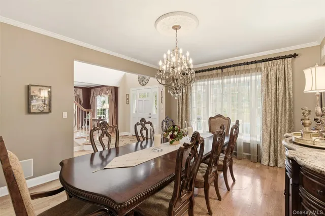 a view of a dining room with furniture and chandelier