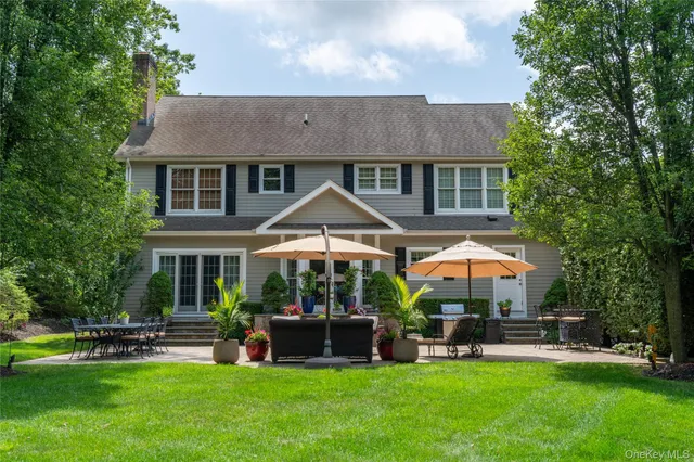 a view of a house with a yard and sitting area