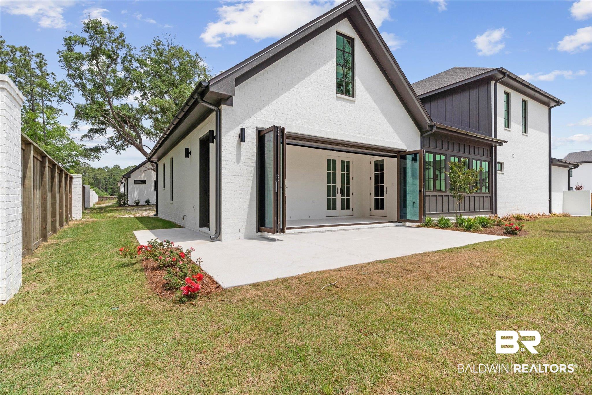 853 Inlet Circle Gulf Shores, AL 36542 - Photo 40 of 55 Rear view of property with a yard, fence, board and batten siding, and a patio area
