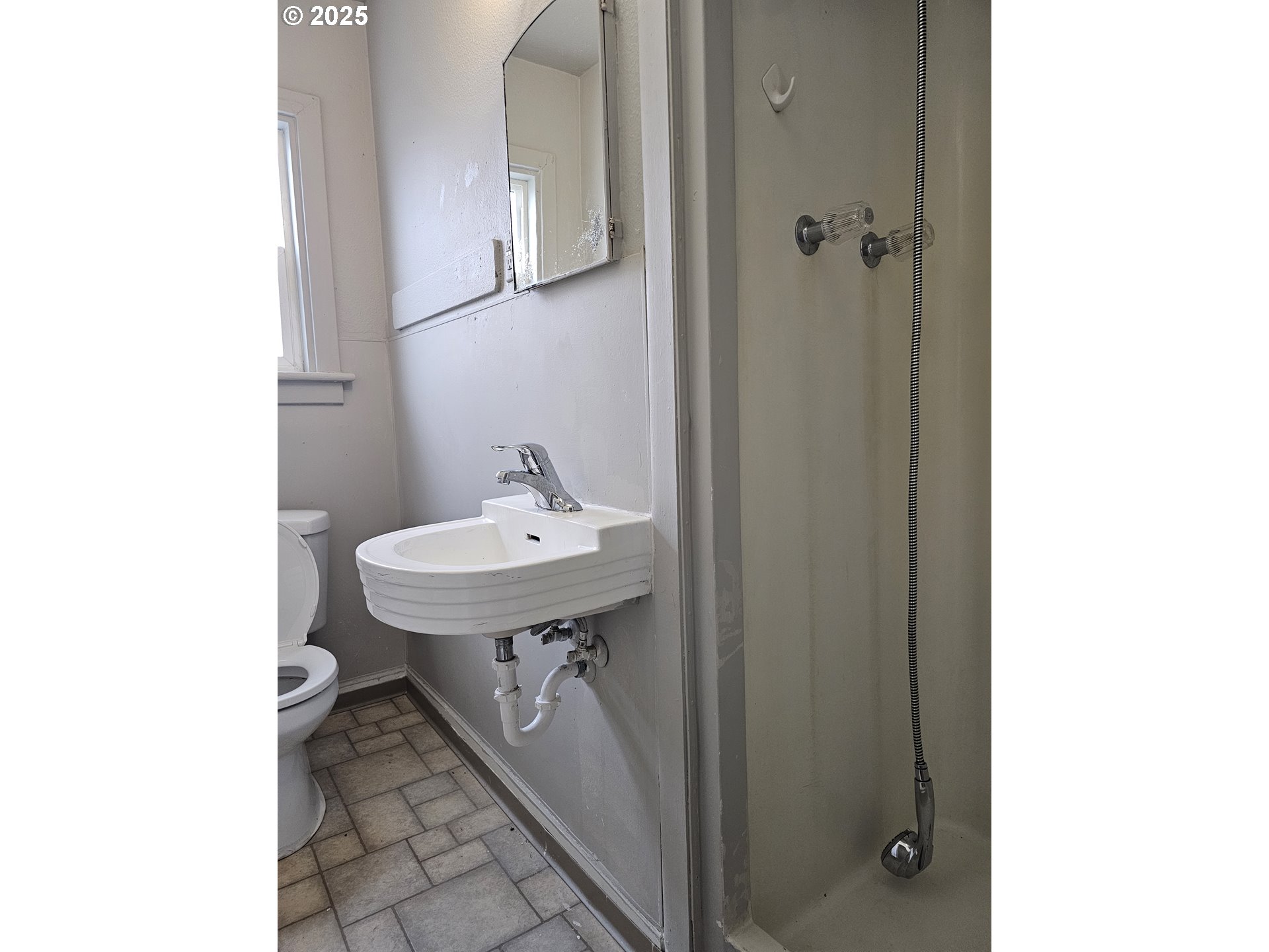 709 Southwest Frazer Avenue Pendleton, OR 97801 - Photo 18 of 28 a bathroom with a sink a mirror and a toilet