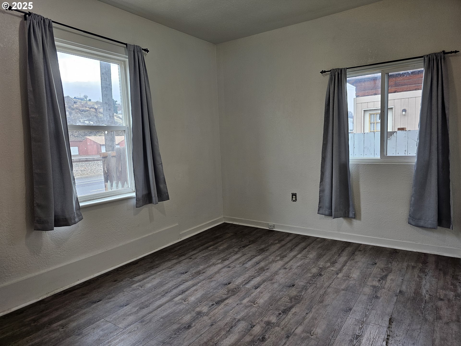 709 Southwest Frazer Avenue Pendleton, OR 97801 - Photo 21 of 28 a view of an empty room with wooden floor and a window