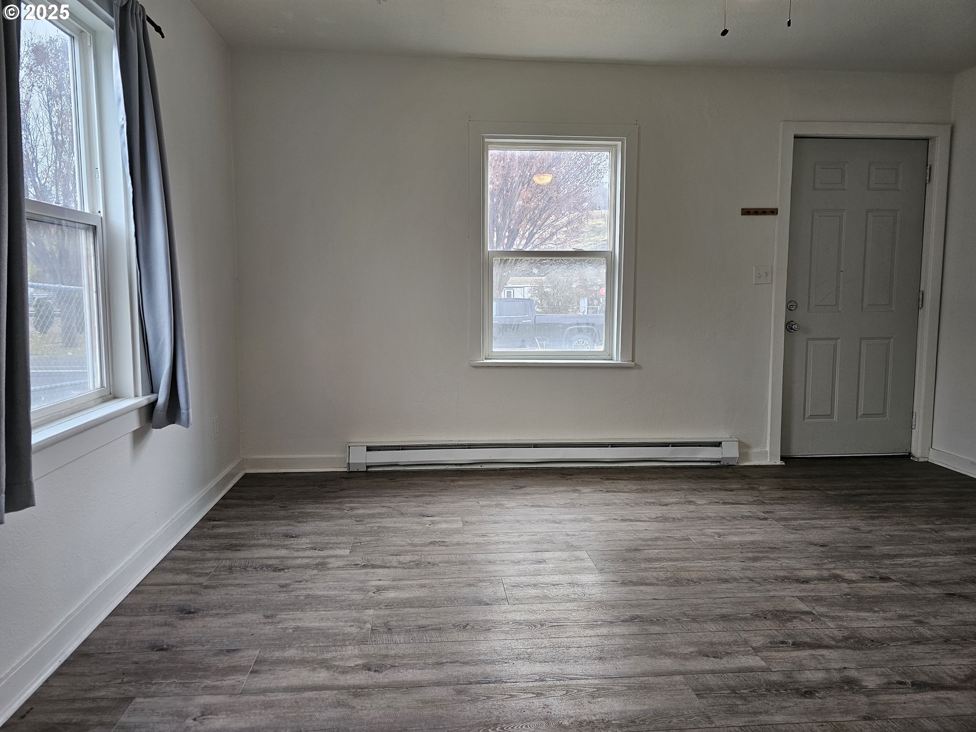 709 Southwest Frazer Avenue Pendleton, OR 97801 - Photo 6 of 28 a view of an empty room with wooden floor and a window