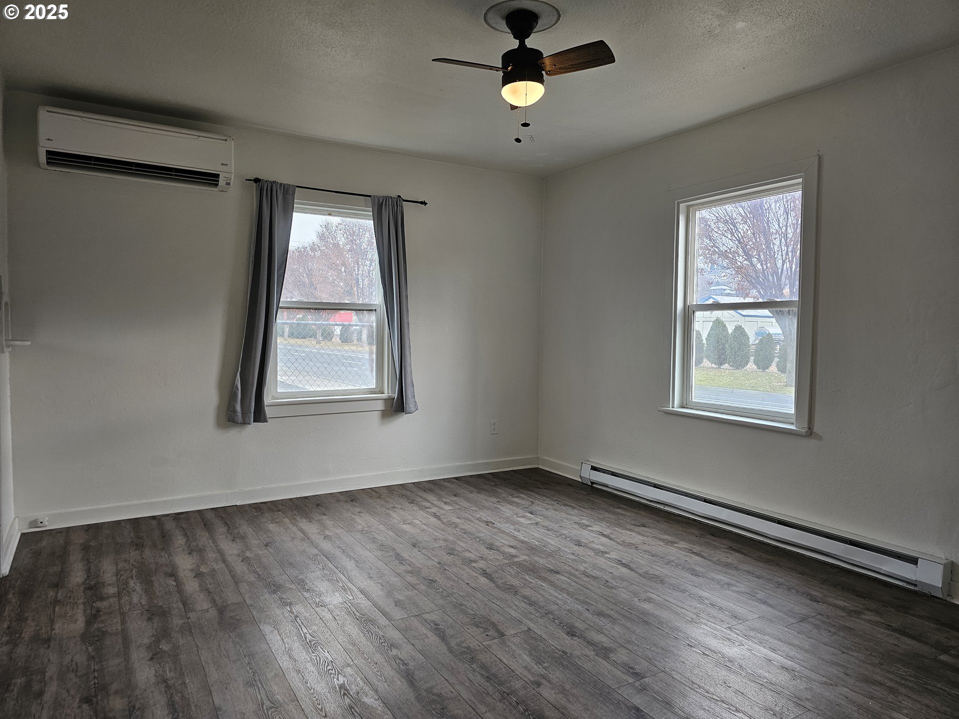 709 Southwest Frazer Avenue Pendleton, OR 97801 - Photo 7 of 28 a view of an empty room with wooden floor and a window