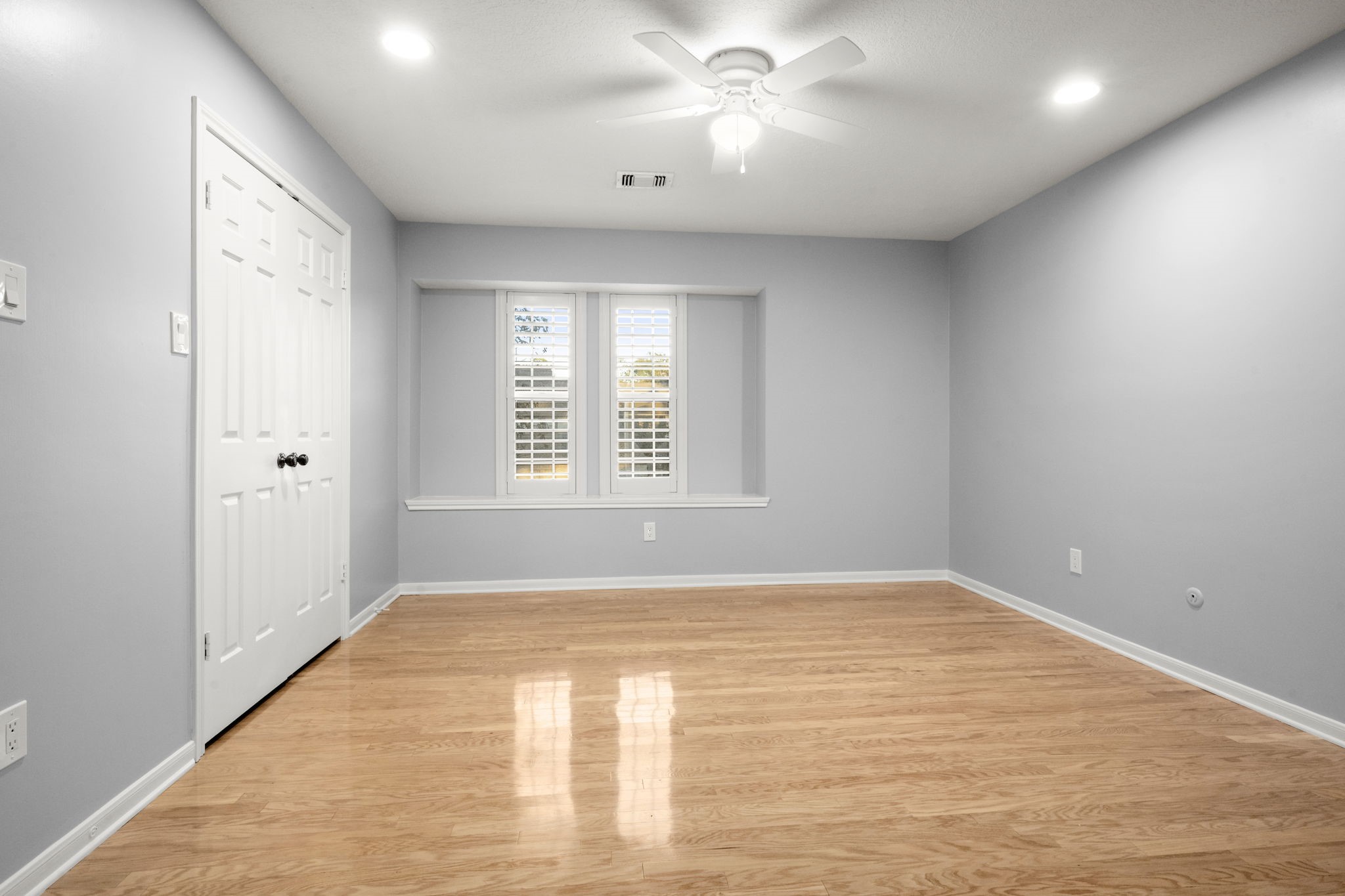 16111 Maplehurst Drive Spring, TX 77379 - Photo 18 of 30 a view of an empty room with wooden floor and a window