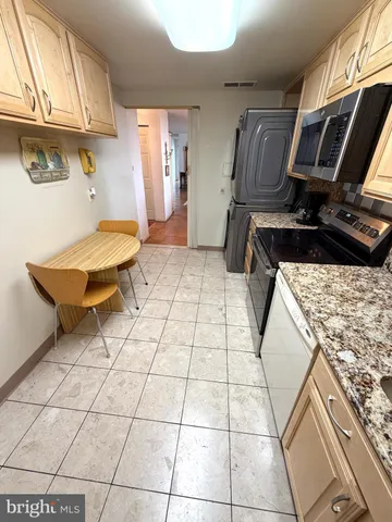 a view of a cafe with a table and chairs under an umbrella