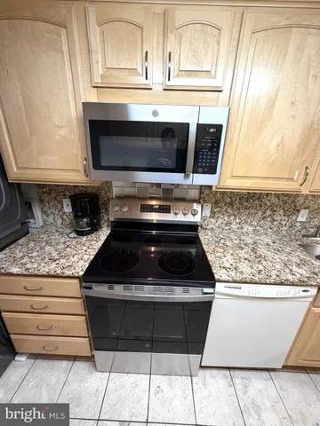 a street sign on a sidewalk next to a road