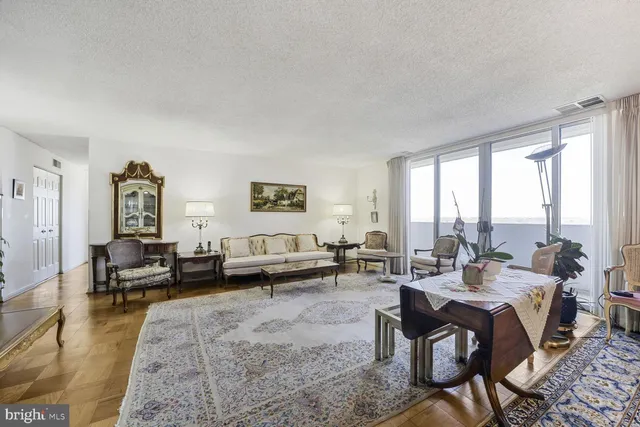 a kitchen with granite countertop a sink a stove top oven and cabinets