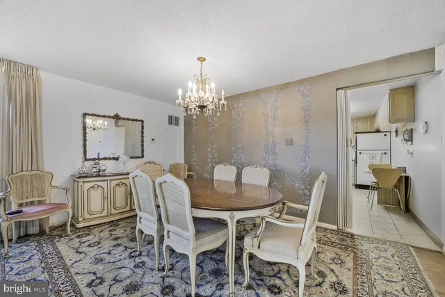 a living room with a washing machine and flat screen tv