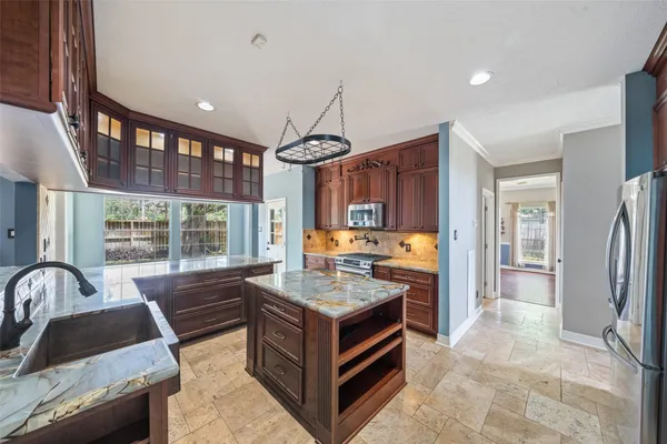 a living room with stainless steel appliances granite countertop furniture and a fireplace