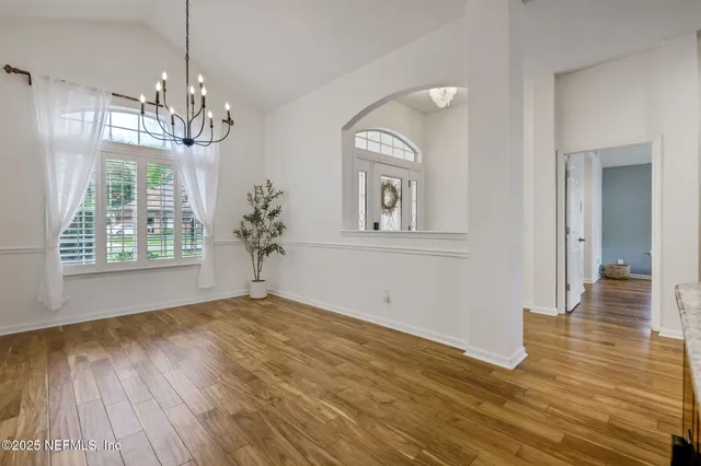 a view of a kitchen with furniture and wooden floor