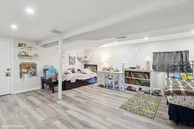 a bedroom with furniture and a wooden floor