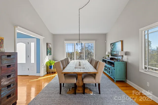 a view of a dining room with furniture window and wooden floor
